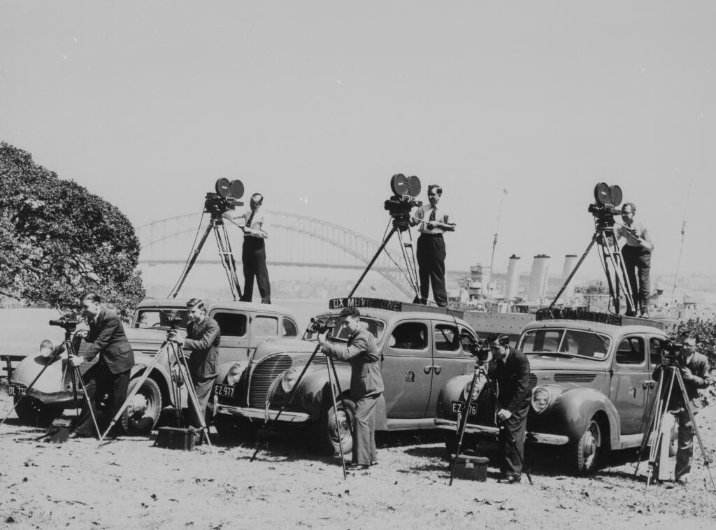 Antique photo of men filming with cameras
